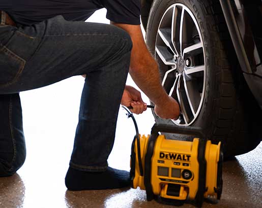 man filling tire on luxury care